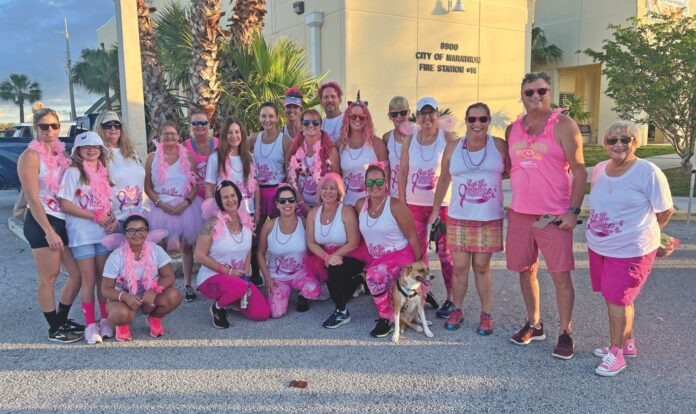 IMG_7957 fc a group of women in pink and white shirts posing for a picture