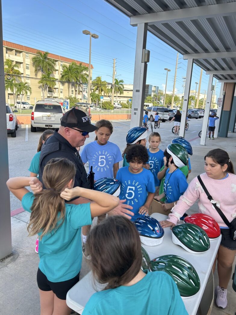 a group of people standing around a table