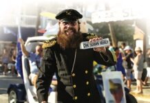 a man in a military uniform holding a sticker