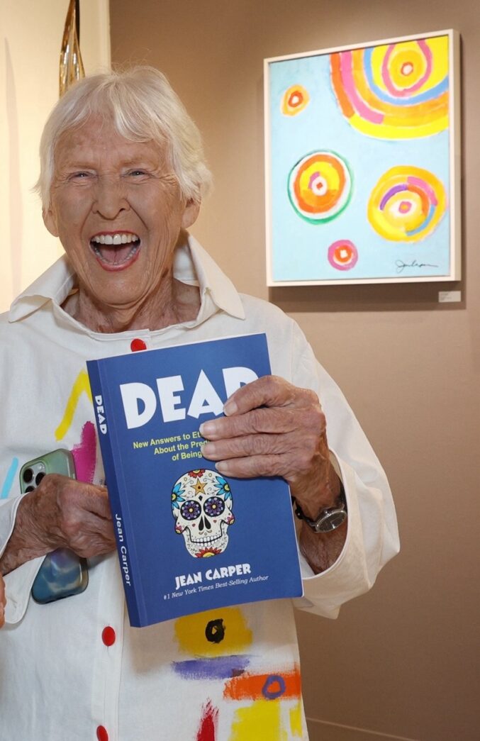 an older woman holding a book in her hands