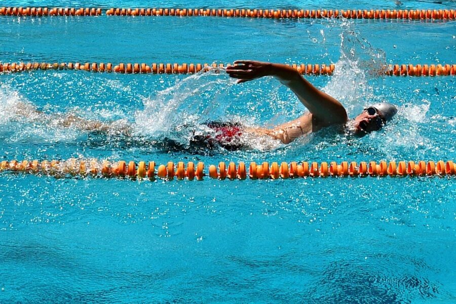 a man swimming in a swimming pool