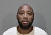 a mug shot of a man in a white shirt