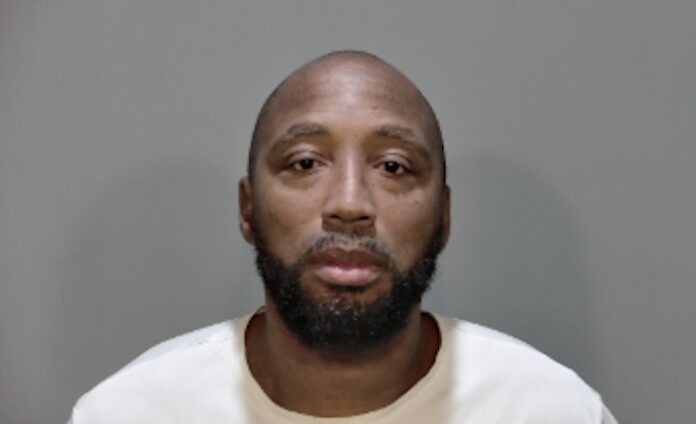 a mug shot of a man in a white shirt