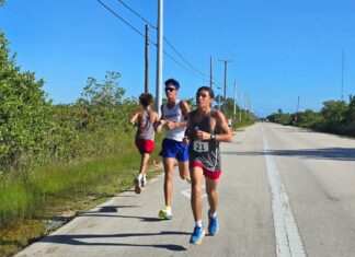 DOLPHIN HARRIERS BURNS & JOLY CLAIM FIRSTS ON MUDDY BIG PINE COURSE a group of people running down a road