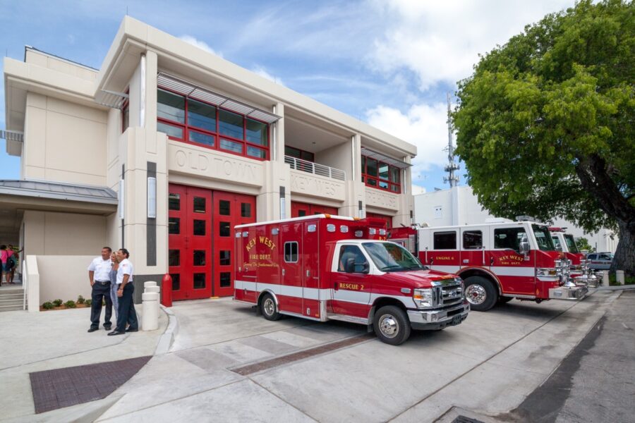a group of fire trucks parked in front of a fire station