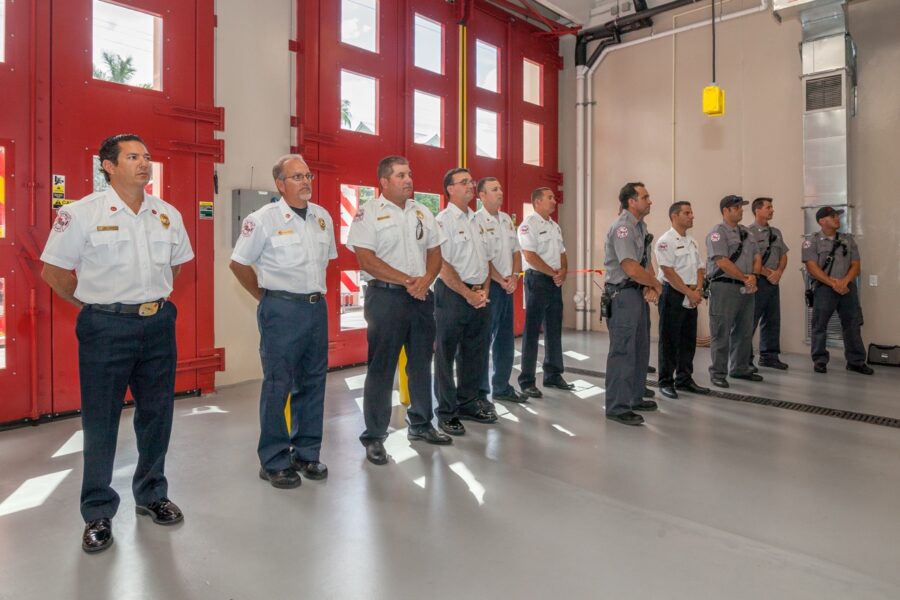 a group of men standing in front of a red door