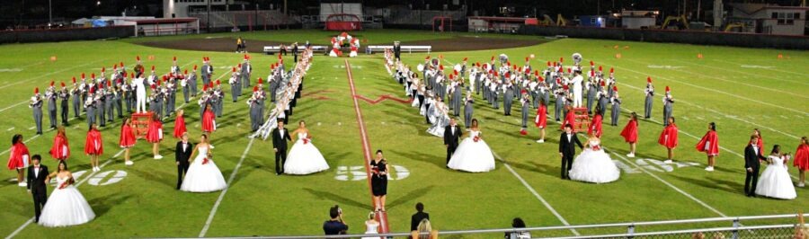 a large group of people standing on top of a field