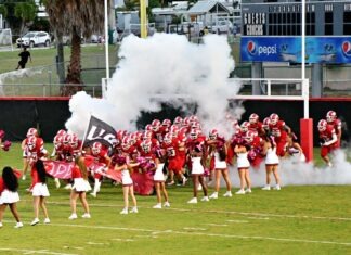 KEY WEST HOMECOMING: 75 YEARS OF CONCH PRIDE a group of cheerleaders on a football field