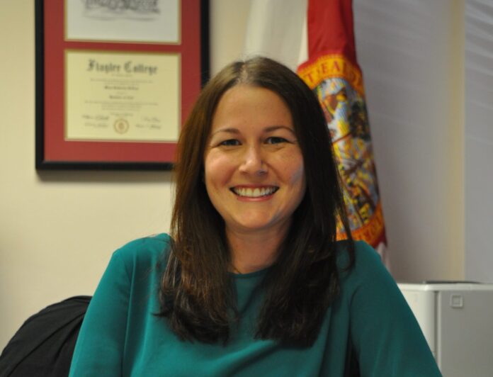 Kate DeLoach a woman sitting at a desk in an office