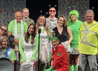 THE KEY PLAYERS PRESENT A SCI-FI DOUBLE-HEADER a group of people standing on top of a stage