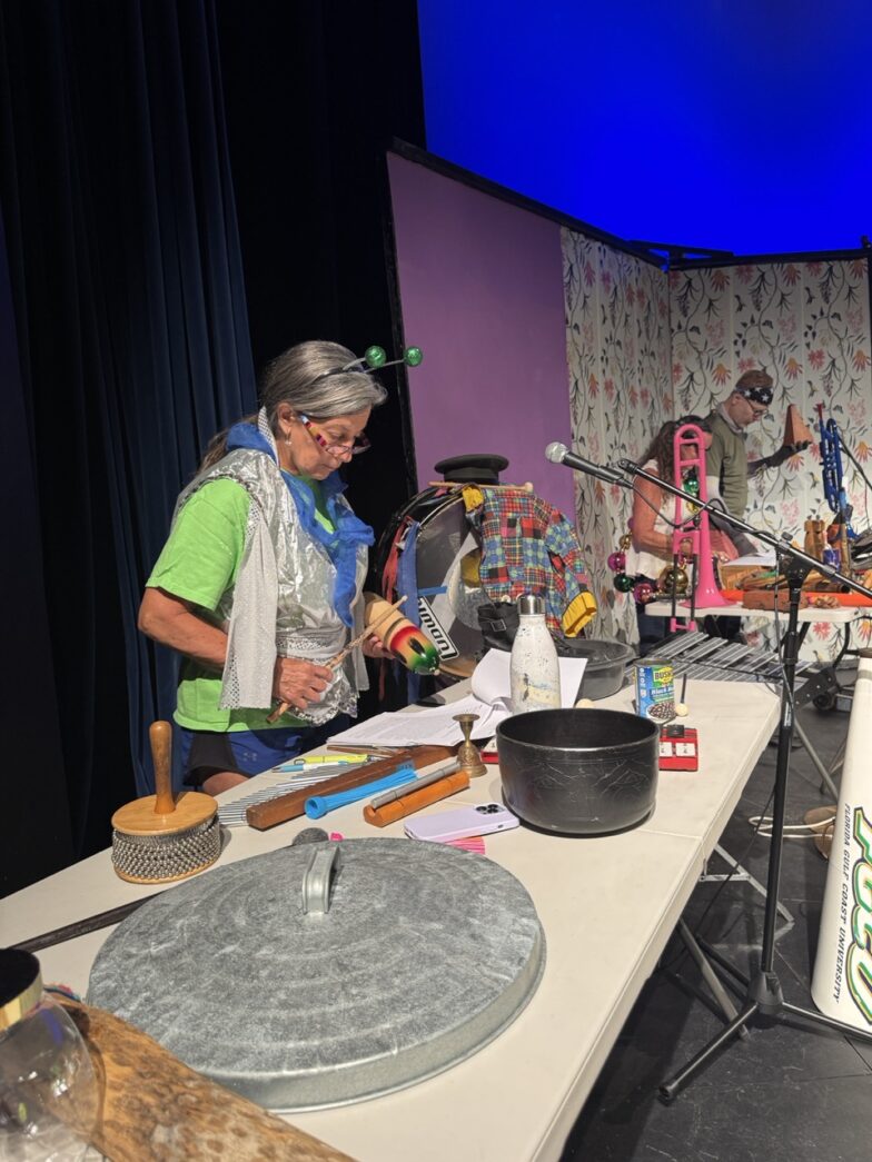 a group of people standing around a table