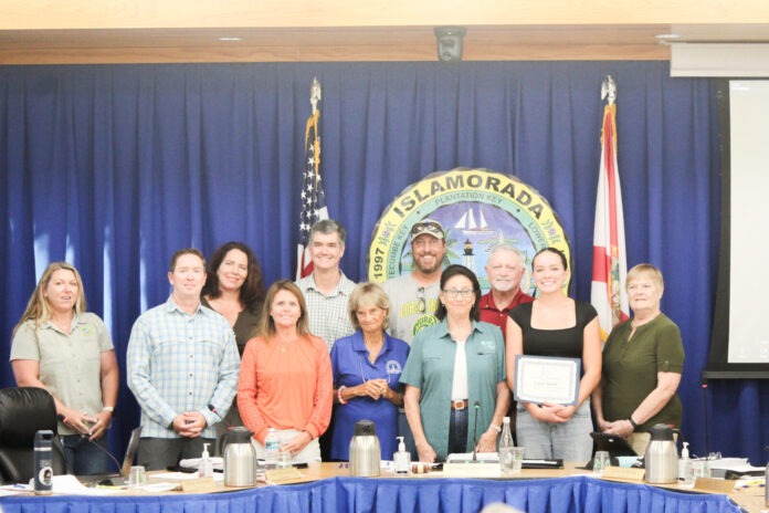 a group of people standing in front of a table
