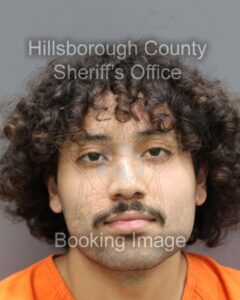 a mug shot of a man with curly hair