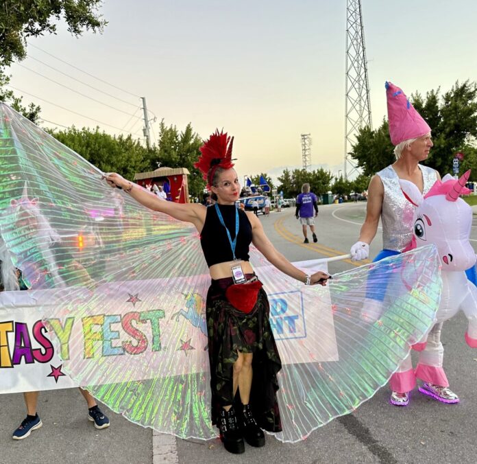 Liz unicorn a group of people that are standing in the street