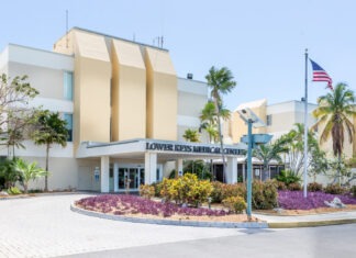 WHAT’S HAPPENING WITH THE KEY WEST HOSPITAL LEASE?  a large building with a flag on top of it