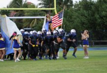 a group of people on a field with a flag