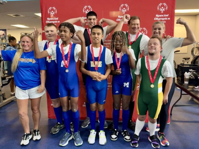 Marthon and CSH Powerlifting Large a group of young people standing next to each other