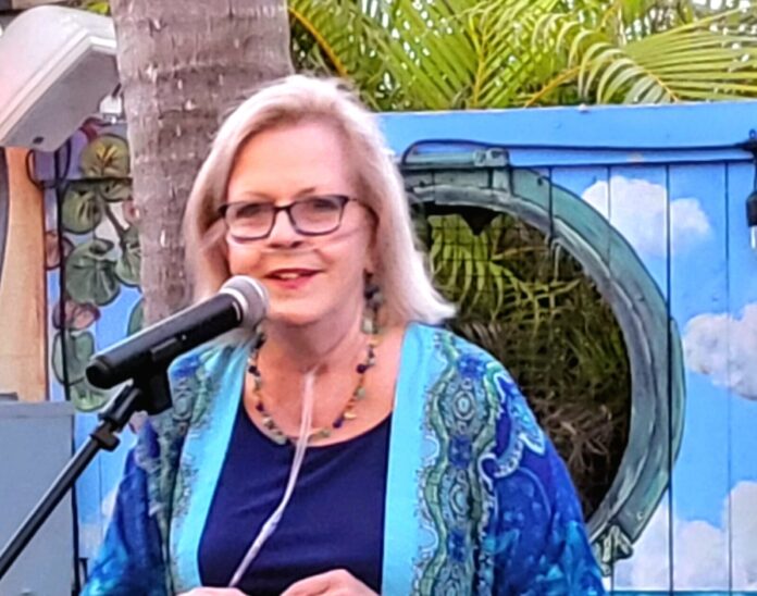 a woman standing in front of a microphone