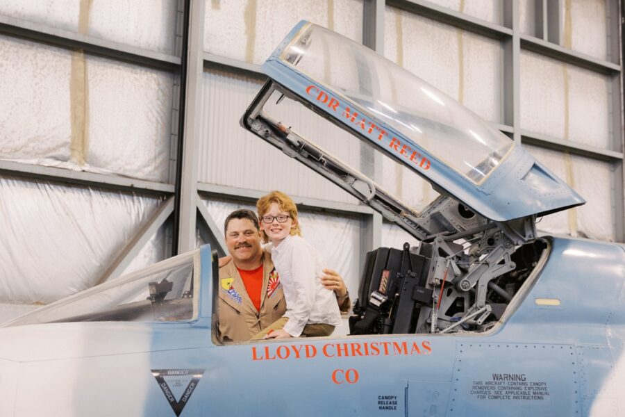 a man and a woman sitting in the cockpit of an airplane