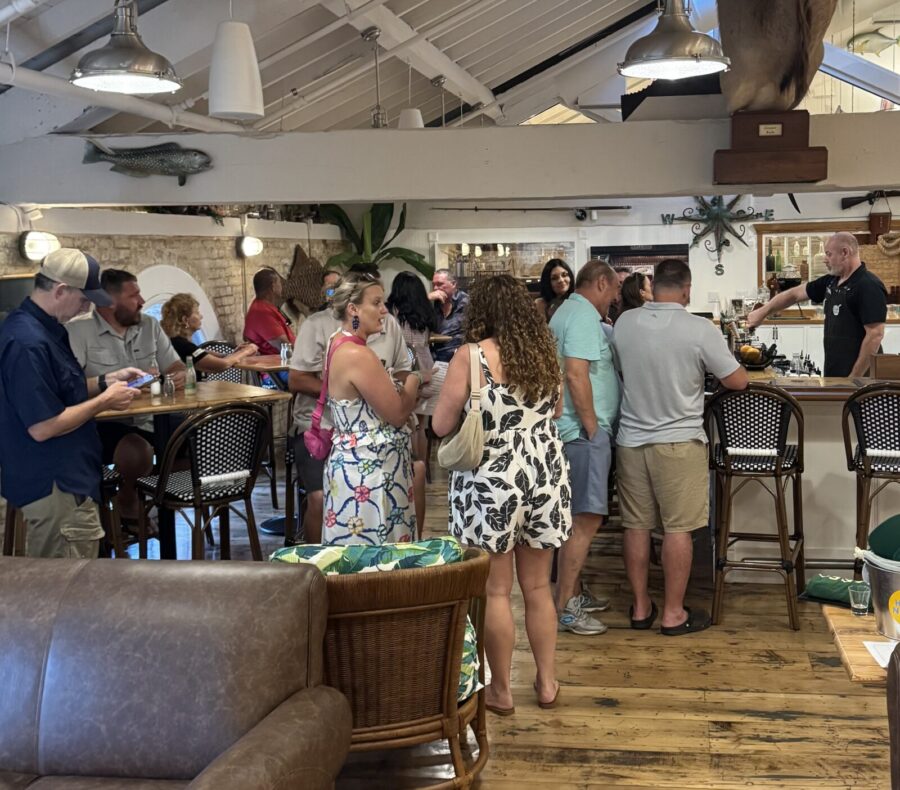 a group of people standing around a bar