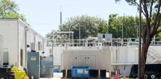 a parking lot with a building in the background