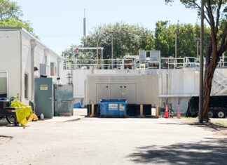 a parking lot with a building in the background