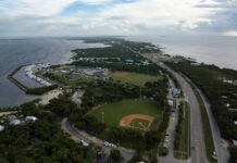 an aerial view of a baseball field next to the ocean