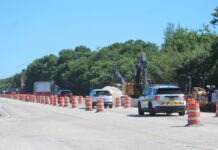 a construction area with construction cones and cars