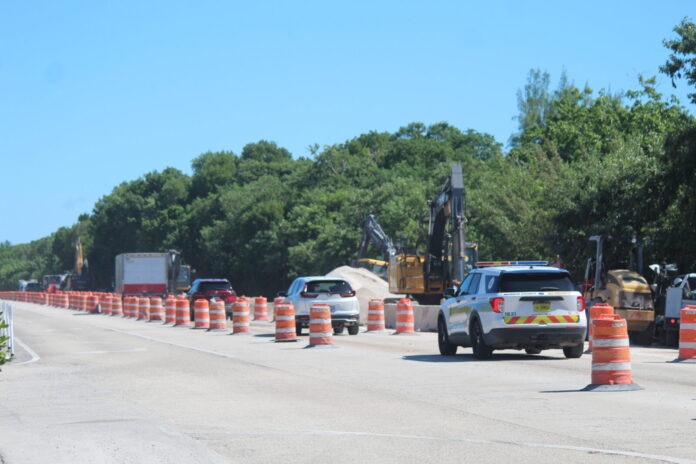a construction area with construction cones and cars