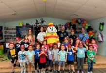 a group of children and adults posing for a picture
