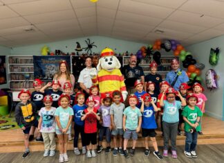 a group of children and adults posing for a picture