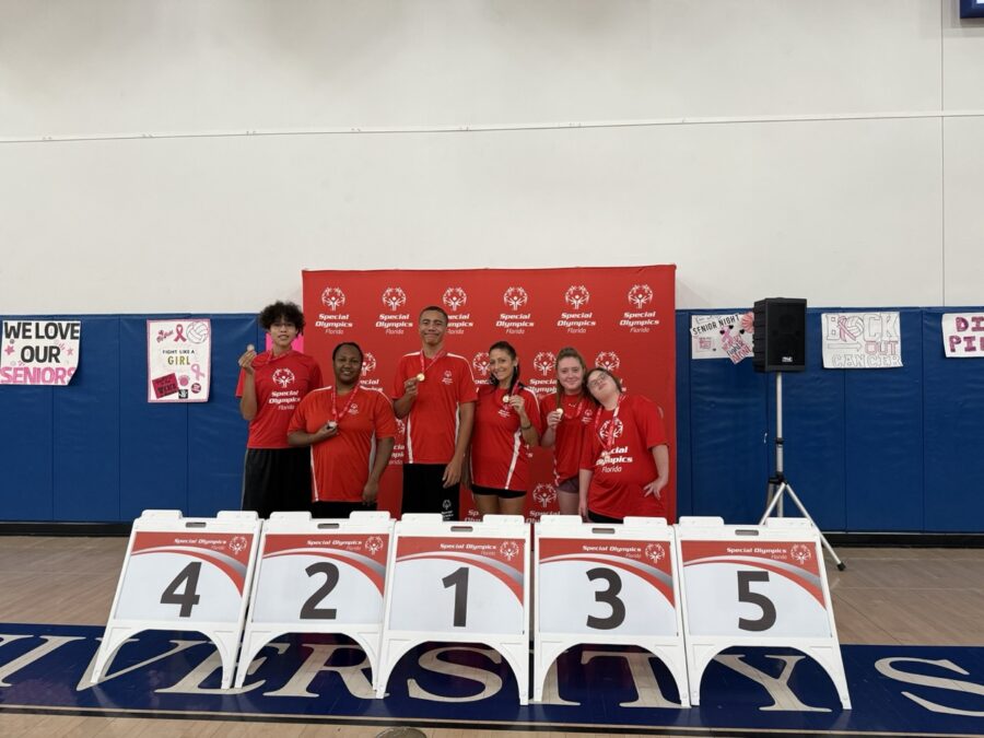 a group of people standing on top of a basketball court