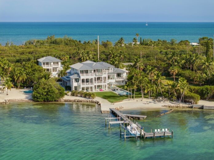 an aerial view of a home on the water