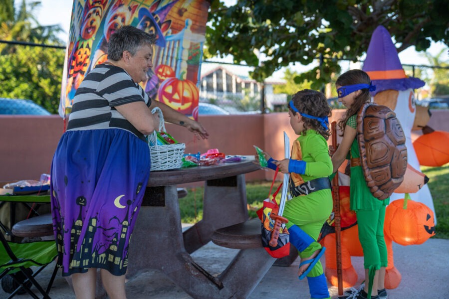 a group of people standing around a table