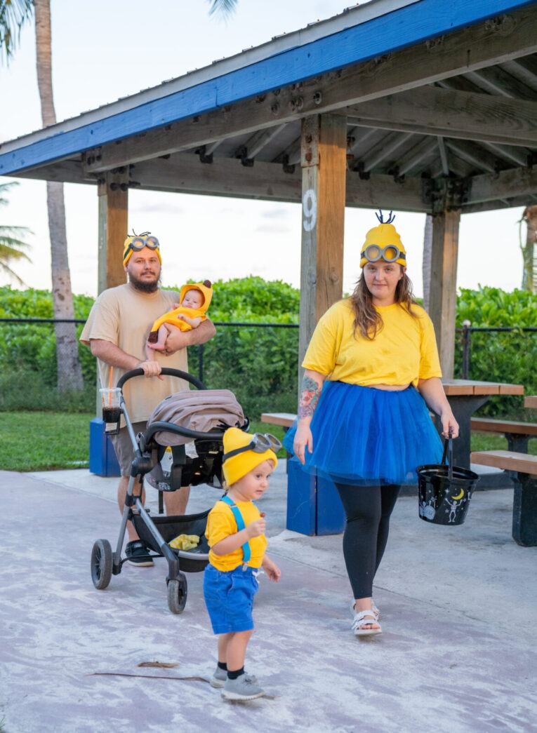 a man and a woman walking with a baby in a stroller