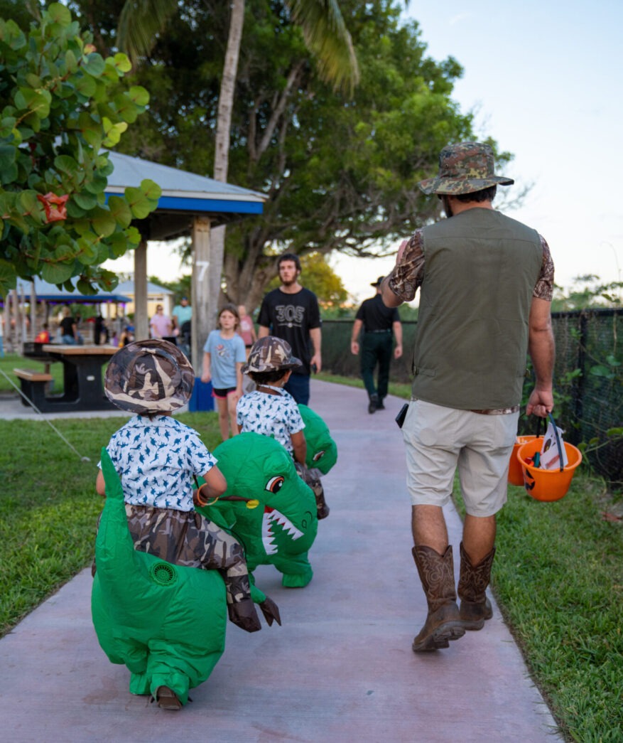 a group of people walking down a sidewalk