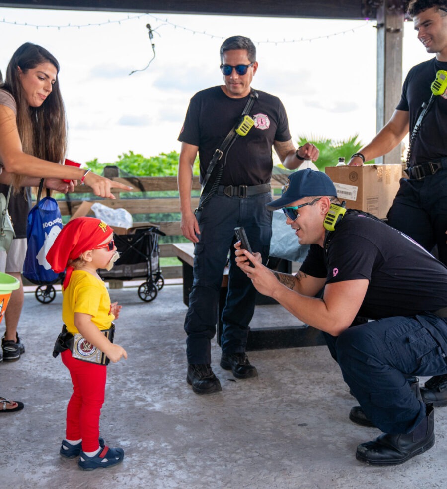 a group of people standing around a little girl