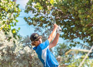 a man swinging a golf club on a golf course