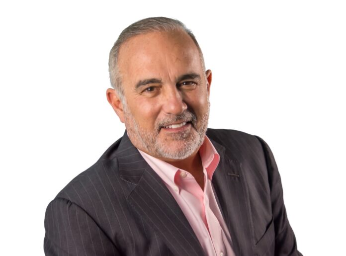 a man wearing a suit and pink shirt