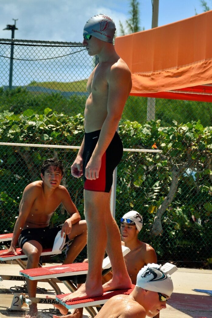 a man standing on top of a swimming pool