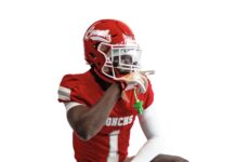 a man in a football uniform holding a football