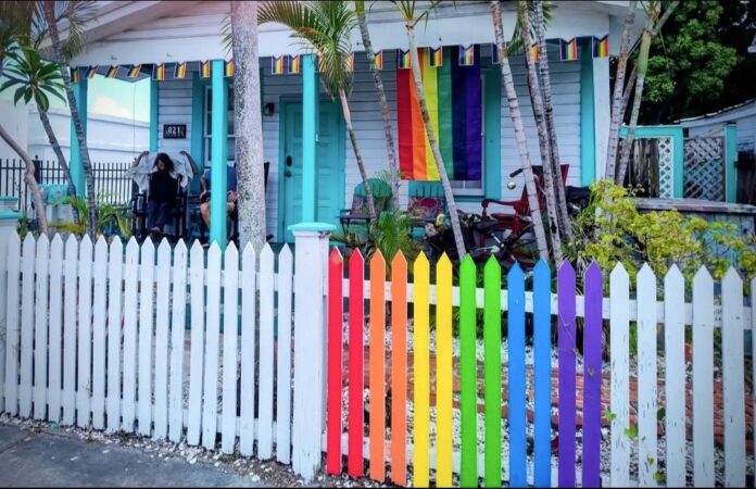 Susan Kent house Large a rainbow colored house with a white picket fence