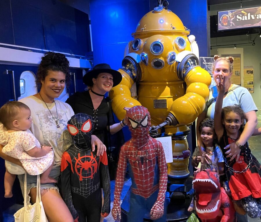 a group of people standing next to a giant robot