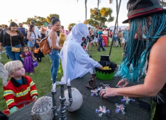 UPPER KEYS TRANSFORMS INTO HALLOWEEN TOWN THIS WEEK a group of people standing around a table