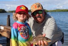 a man and a little girl holding a fish