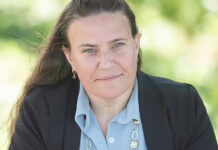 a woman in a blue shirt and black jacket