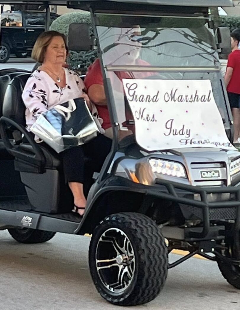 a woman is sitting in a golf cart