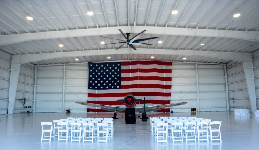 a hangar with a large american flag on the wall