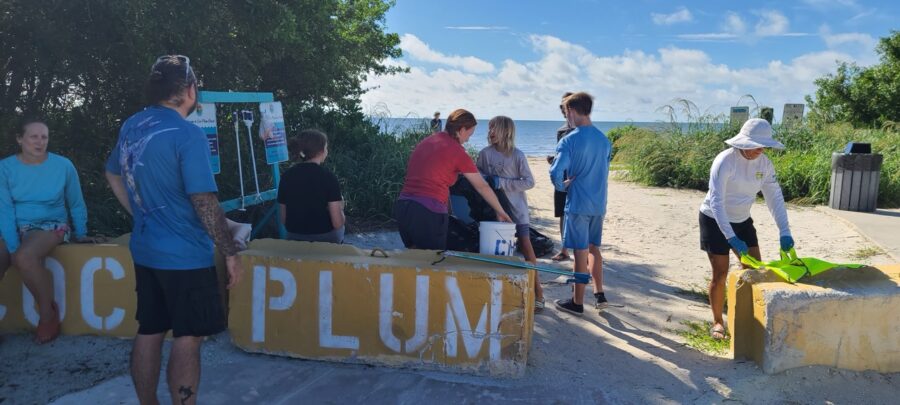 a group of people standing around a sign