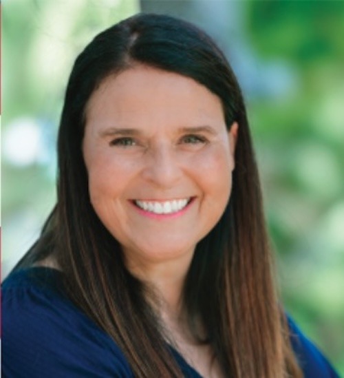 a woman with long hair and a blue shirt